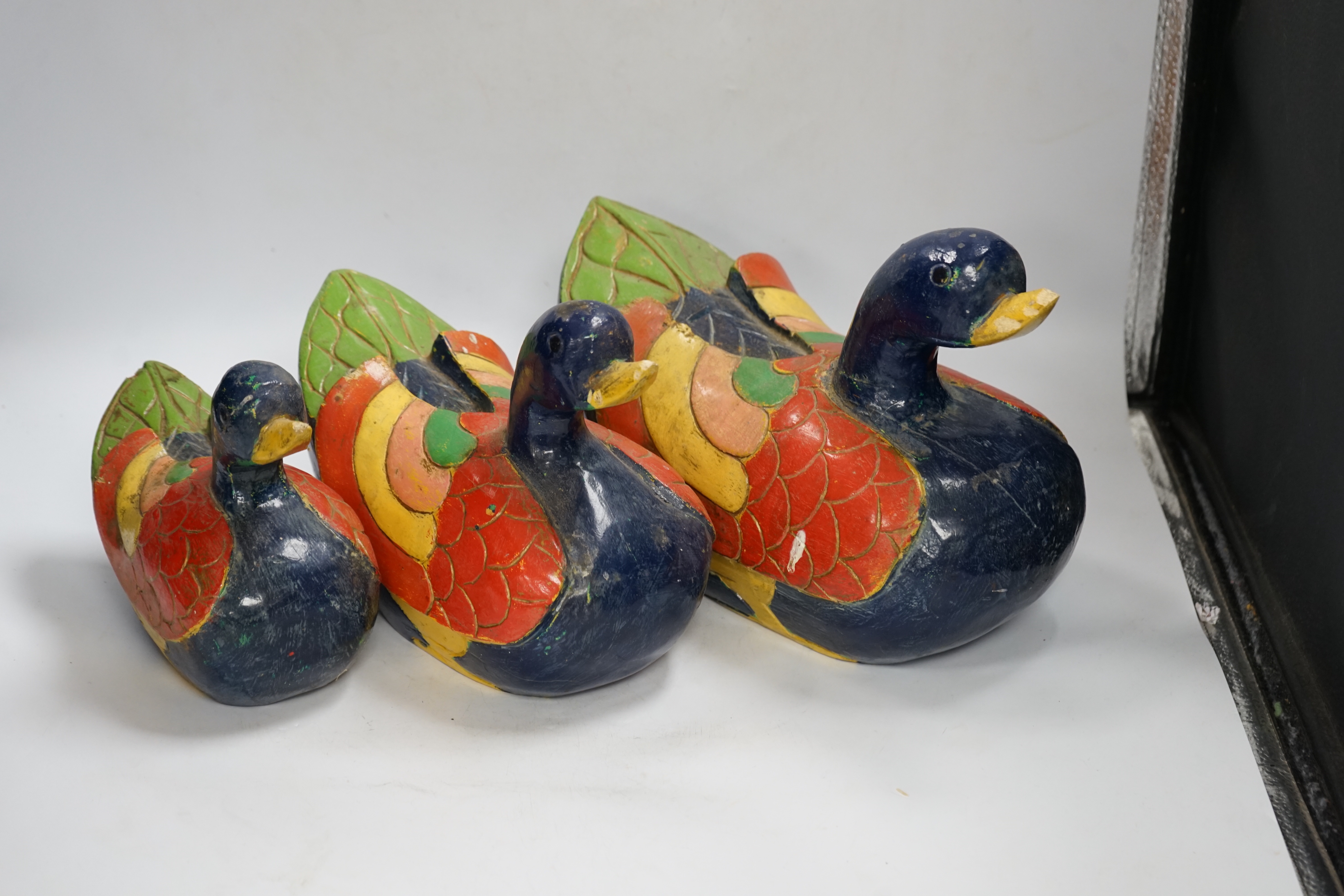 Three graduated carved and painted wood ducks, 31cm